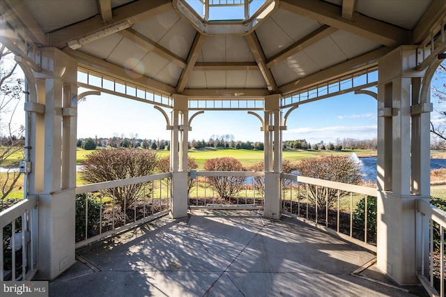 view of patio featuring a gazebo and a water view