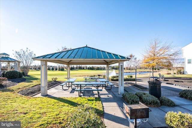 surrounding community featuring a gazebo, a yard, and a water view