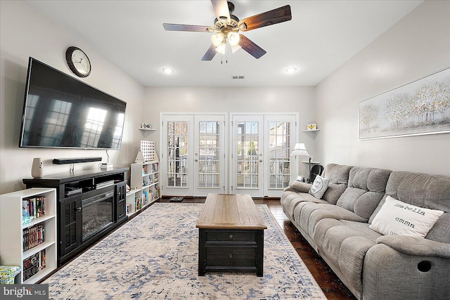 living room with ceiling fan, french doors, and dark hardwood / wood-style floors