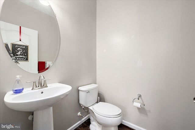 bathroom featuring hardwood / wood-style floors and toilet