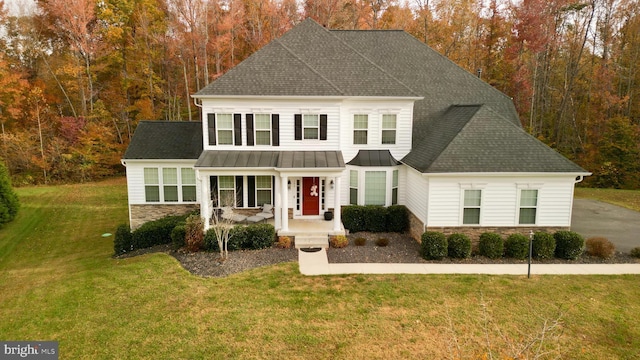 view of front of home with covered porch and a front yard