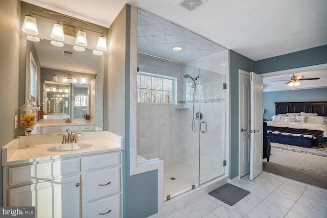 bathroom featuring ceiling fan, vanity, and an enclosed shower