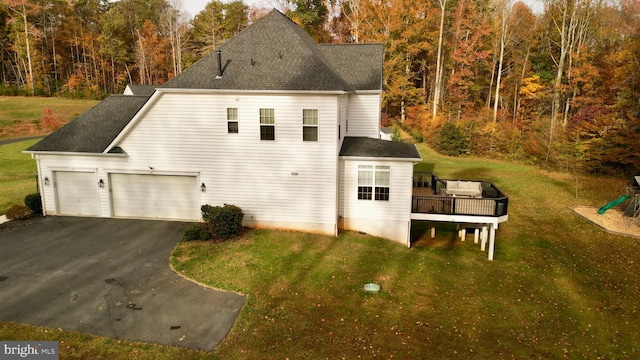 view of home's exterior with a lawn and a wooden deck