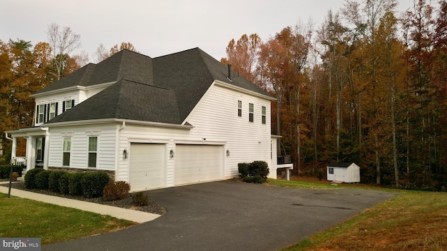 view of property exterior featuring a storage unit and a garage