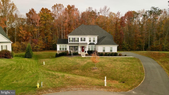 view of front of house with covered porch and a front yard