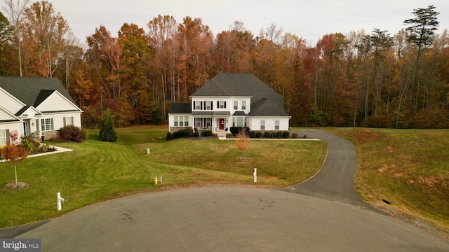 view of front of house with covered porch and a front lawn