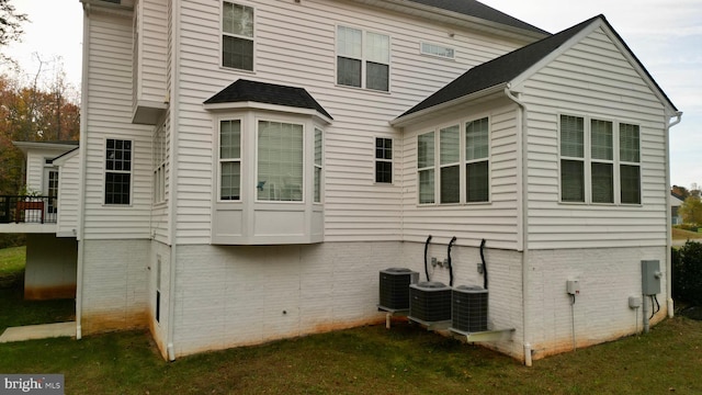 rear view of property featuring cooling unit