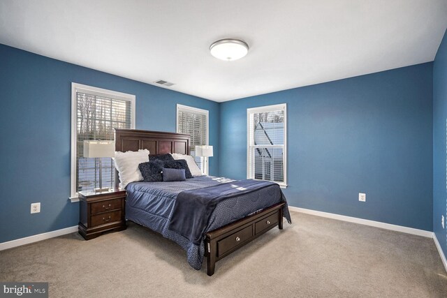 bedroom featuring light colored carpet