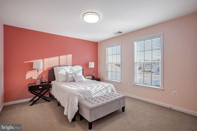 bedroom featuring light colored carpet