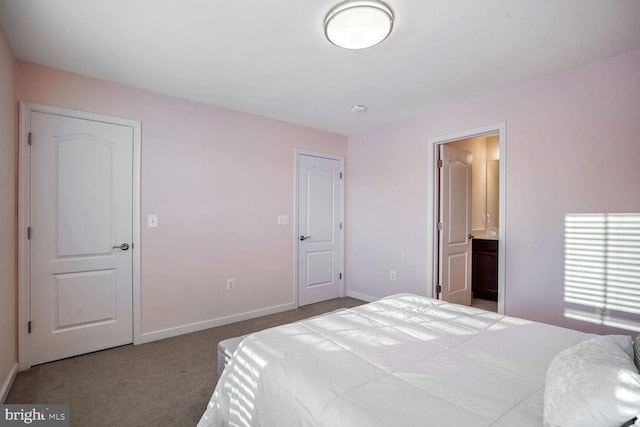 bedroom featuring carpet flooring and connected bathroom