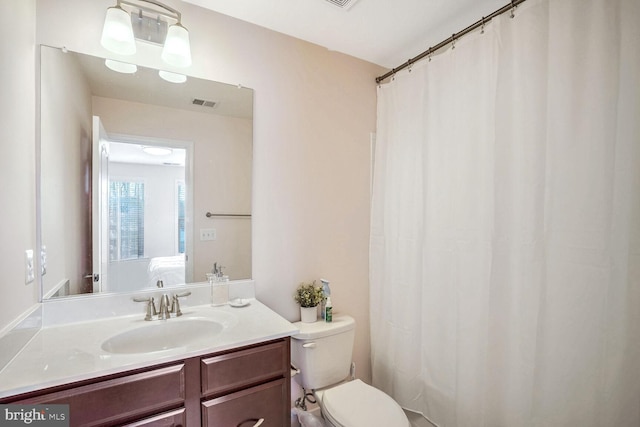 bathroom featuring vanity and toilet