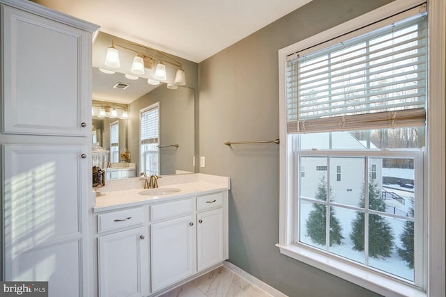 bathroom featuring vanity and a healthy amount of sunlight