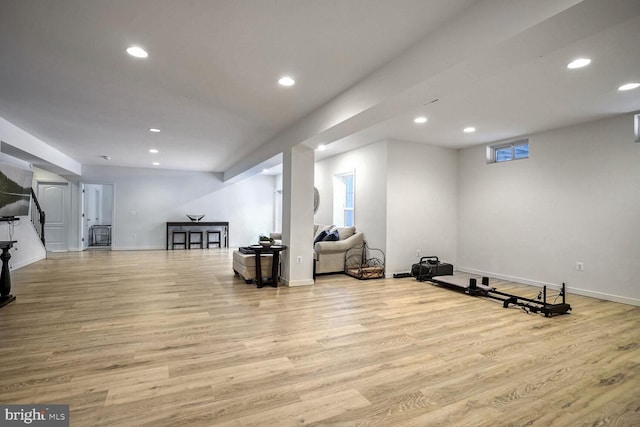 exercise room with light hardwood / wood-style flooring