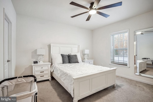 bedroom with light carpet and ceiling fan