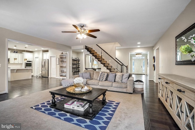 carpeted living room with ceiling fan