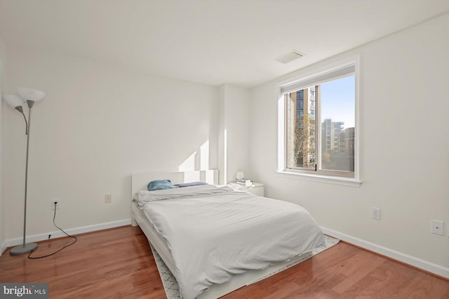 bedroom with hardwood / wood-style floors