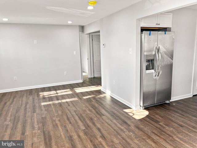 interior space featuring white cabinets, dark hardwood / wood-style flooring, and stainless steel fridge with ice dispenser