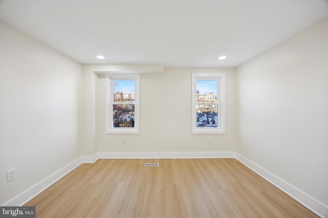 unfurnished room with light hardwood / wood-style floors