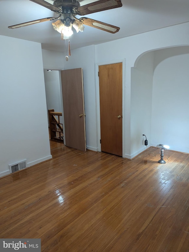 empty room featuring wood-type flooring and ceiling fan