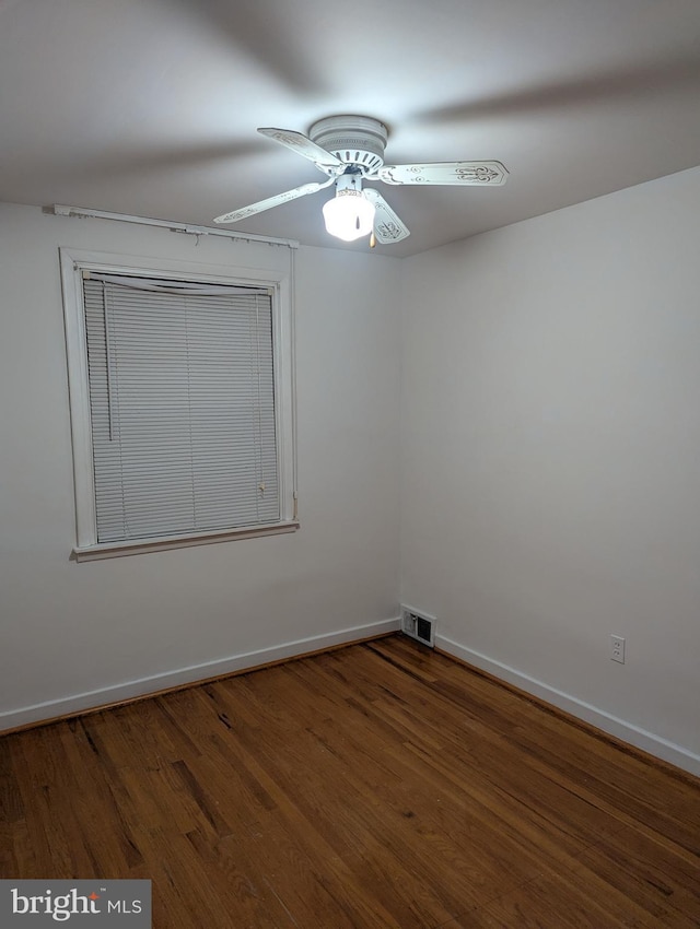 unfurnished room featuring ceiling fan and dark hardwood / wood-style floors