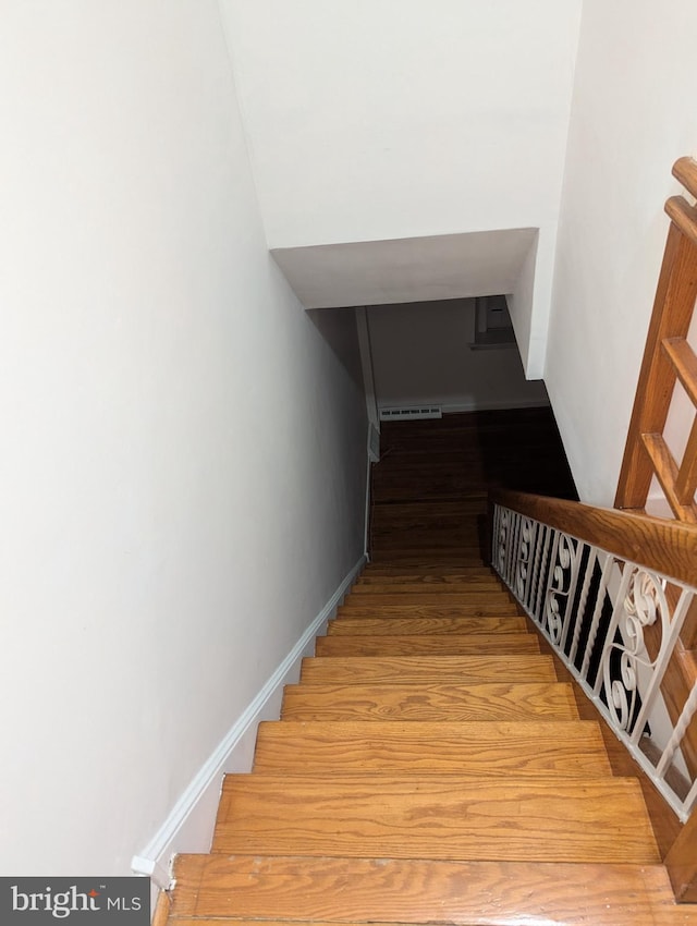 stairway featuring hardwood / wood-style floors