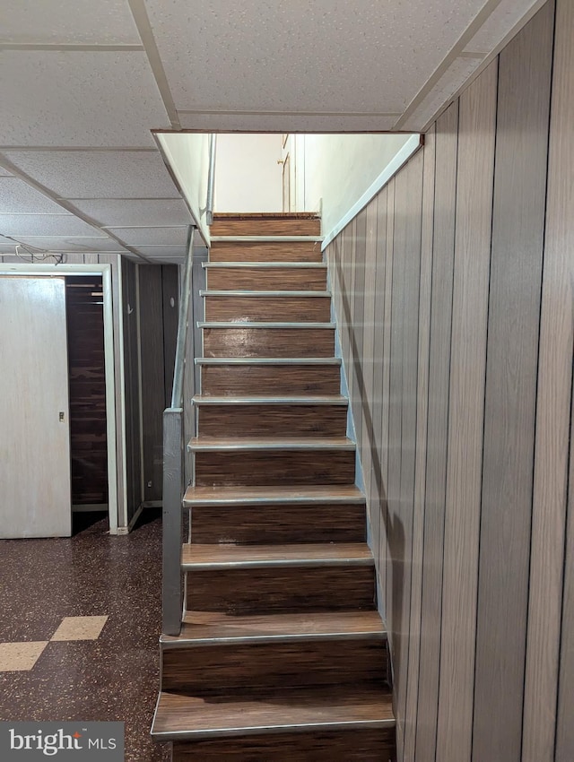 stairway with a paneled ceiling