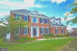 view of front of property with a front yard and central AC