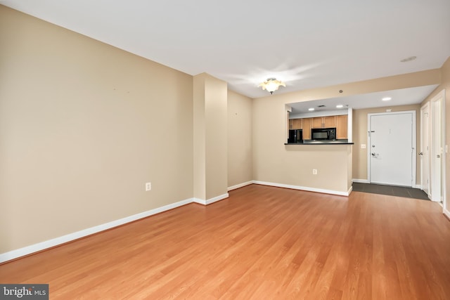 unfurnished living room with light wood-type flooring