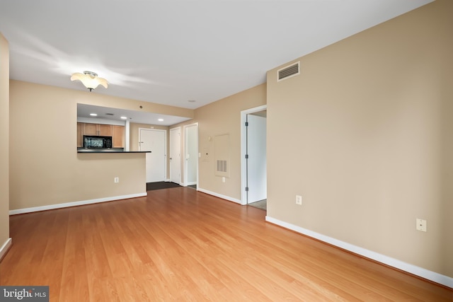 unfurnished living room featuring light hardwood / wood-style flooring