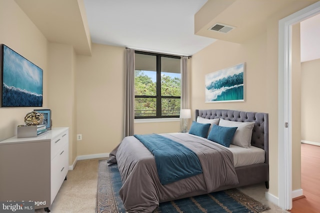 bedroom with light colored carpet