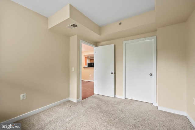 unfurnished bedroom featuring light carpet