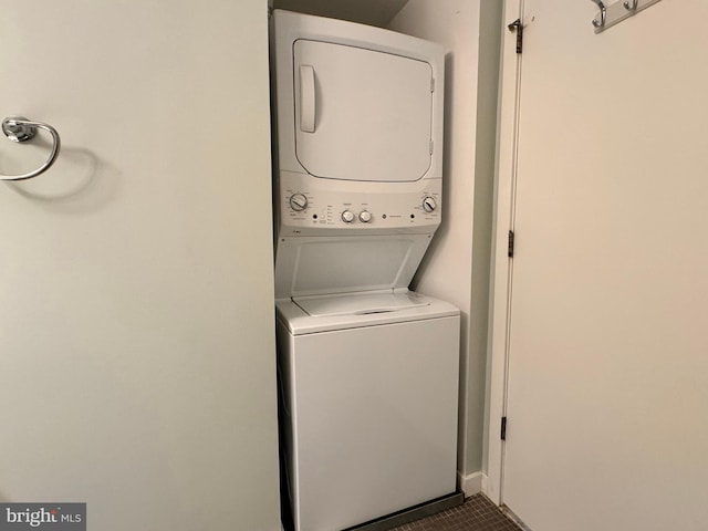 laundry room featuring stacked washer / drying machine