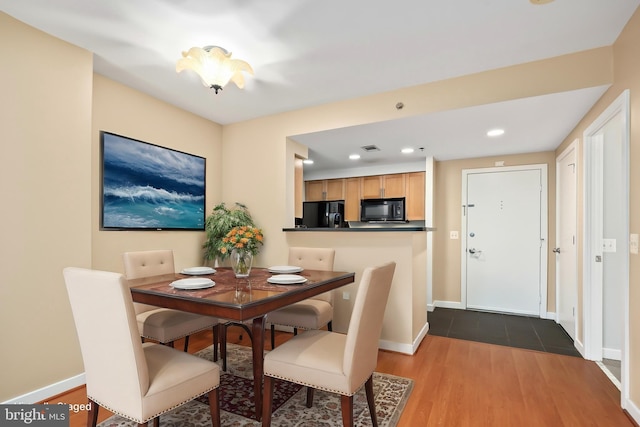 dining space with hardwood / wood-style floors