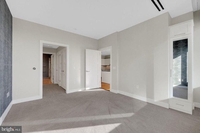 unfurnished bedroom with light colored carpet