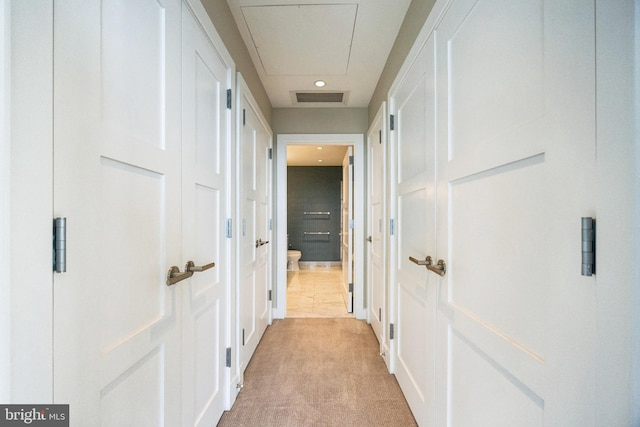 hall featuring light colored carpet