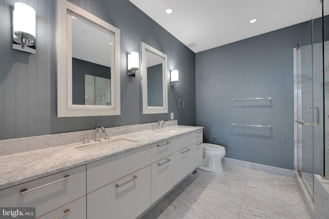 bathroom with vanity, toilet, and a shower with shower door