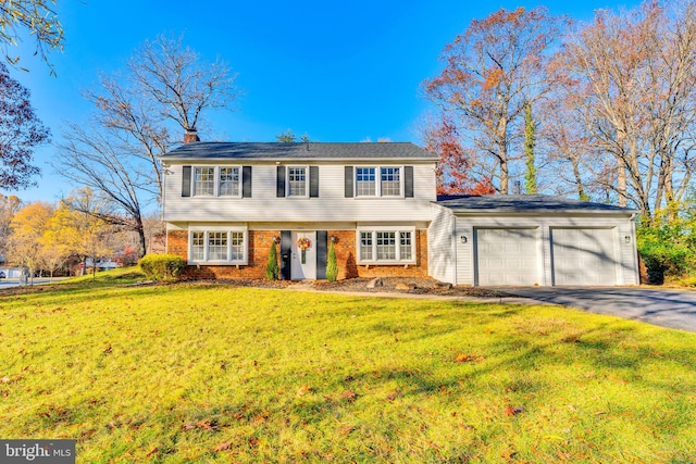 view of front of house featuring a front yard and a garage