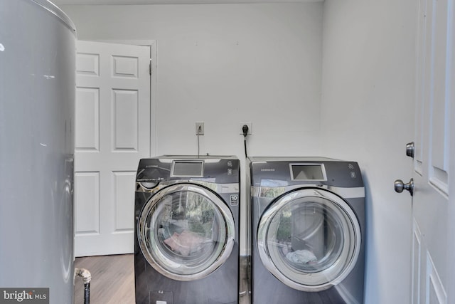 washroom featuring washer and dryer and wood-type flooring