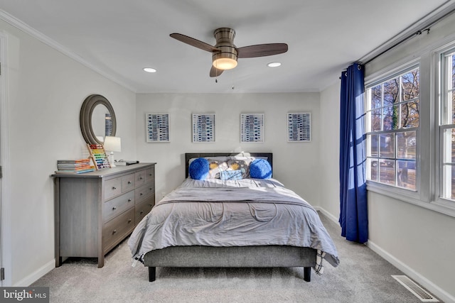 bedroom with light carpet, multiple windows, crown molding, and ceiling fan