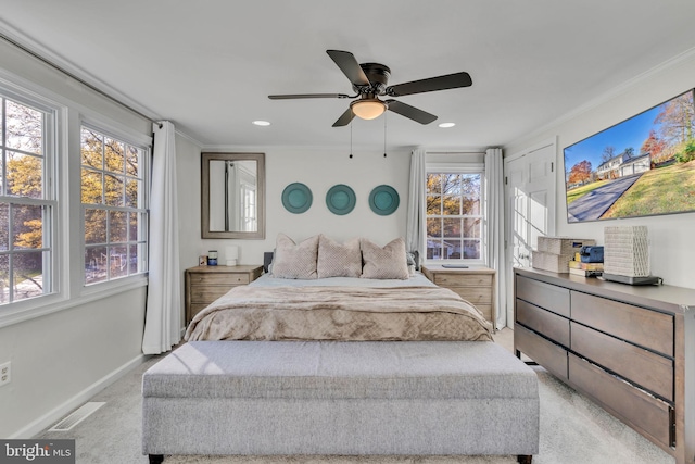 carpeted bedroom with ceiling fan and ornamental molding