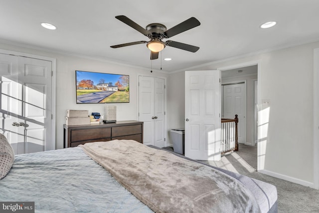 carpeted bedroom featuring ceiling fan and ornamental molding