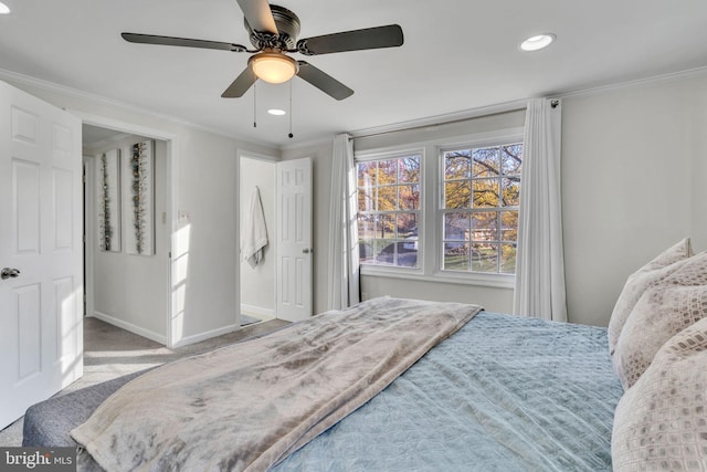 carpeted bedroom featuring ceiling fan and ornamental molding