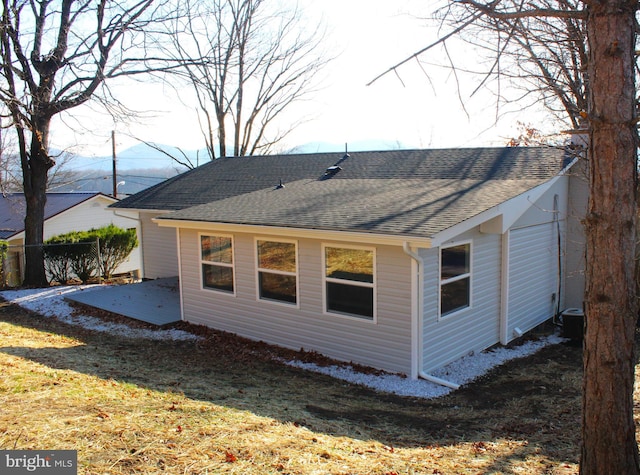 rear view of house with a lawn and a patio