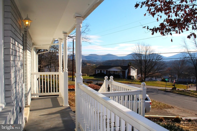 balcony with a mountain view and a porch