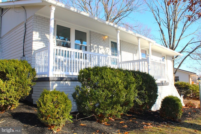 view of property exterior with covered porch