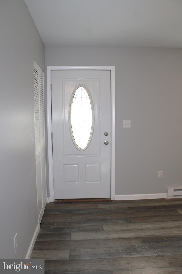 entrance foyer with dark hardwood / wood-style flooring and baseboard heating