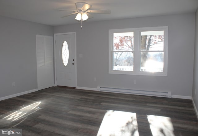 entryway with ceiling fan, dark hardwood / wood-style flooring, and a baseboard heating unit