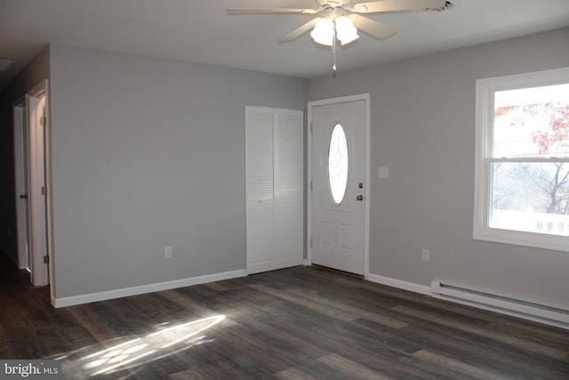 foyer entrance with dark hardwood / wood-style floors, ceiling fan, and a baseboard radiator