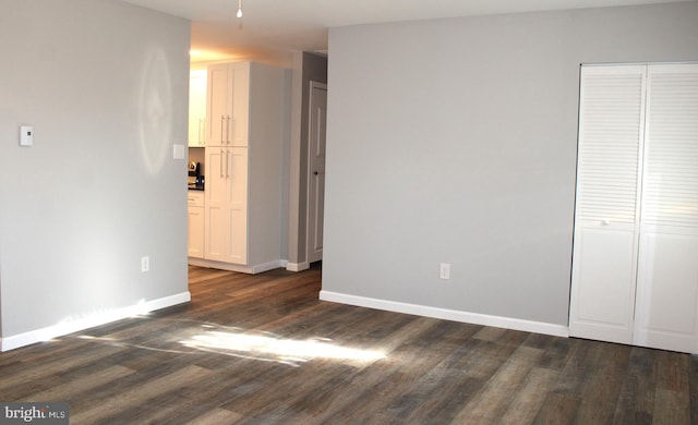 unfurnished bedroom with dark hardwood / wood-style floors