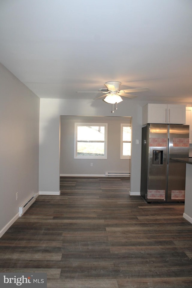 kitchen with white cabinets, dark hardwood / wood-style floors, stainless steel fridge with ice dispenser, and baseboard heating